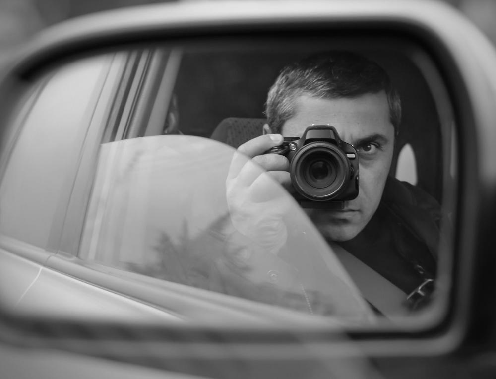man-in-black-and-white-taking-photos-in-car.jpg