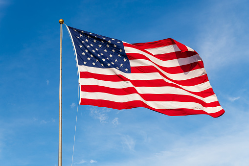 vibrant-colored-american-flag-waving-in-the-wind-lit-by-natural-picture-id1205568263