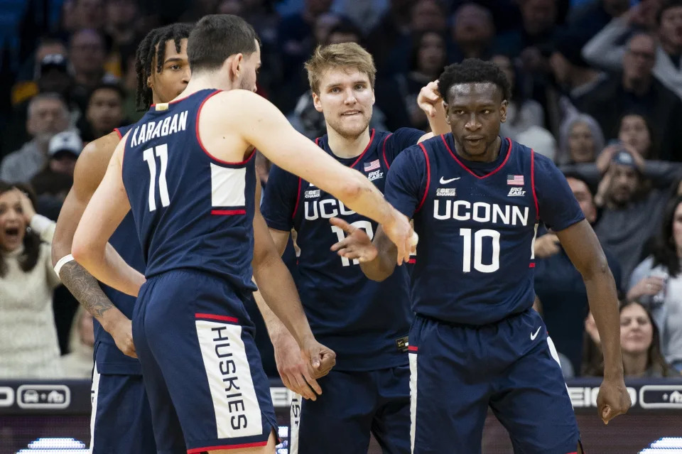 UConn's Hassan Diarra, right, celebrates with his teammates after drawing a foul during the second half of the team's NCAA college basketball game against Villanova on Saturday, Jan. 20, 2024, in Philadelphia. (AP Photo/Chris Szagola)