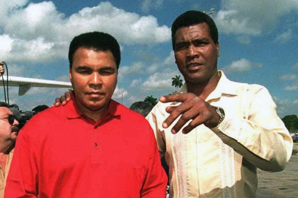Former Cuban boxer Teofilo Stevenson (R), a three-time world amateur boxing champion, greets ...jpeg