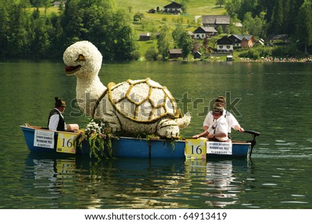 stock-photo-bad-aussee-austria-may-unidentiefied-people-on-boats-with-flover-figures-by-yearly-festival-64913419.jpg