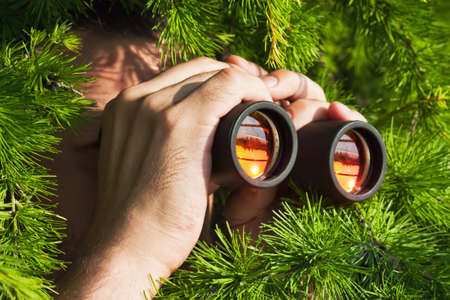 15448723-watching-from-the-bushes-with-binoculars.jpg