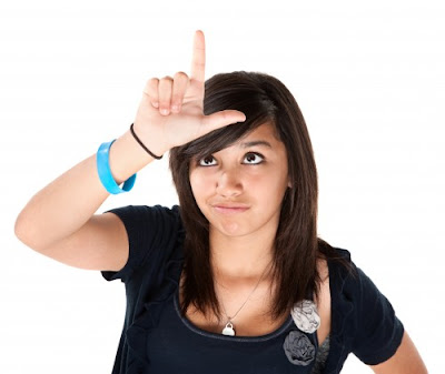 girl-making-the-loser-sign-on-her-forehead.jpg