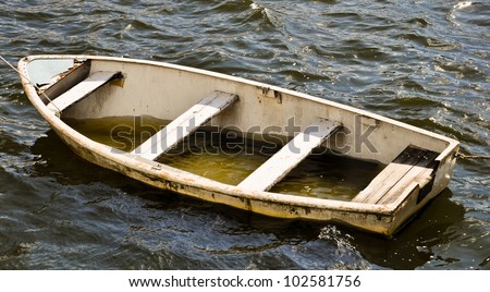 stock-photo-leaky-life-boat-filled-with-water-102581756.jpg