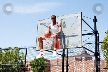 cutcaster-photo-100360184-Basketball-player-sitting-in-hoop.jpg