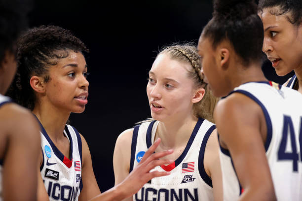 paige-bueckers-of-the-uconn-huskies-huddles-with-teammates-during-the-picture-id1308346216